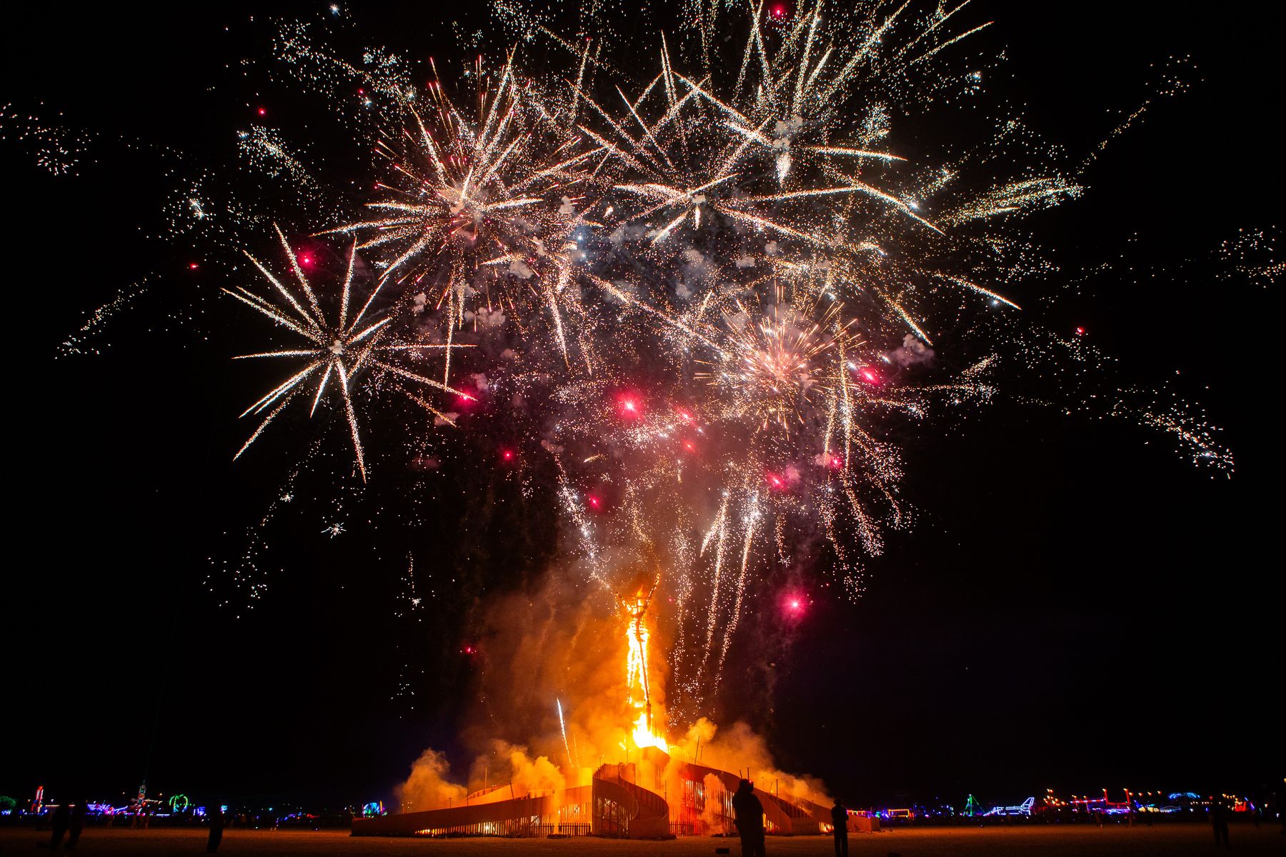 Fireworks bursting over the Man at Burning Man