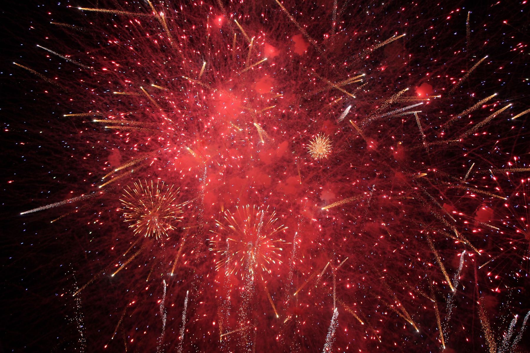 A red fireworks burst filling the sky